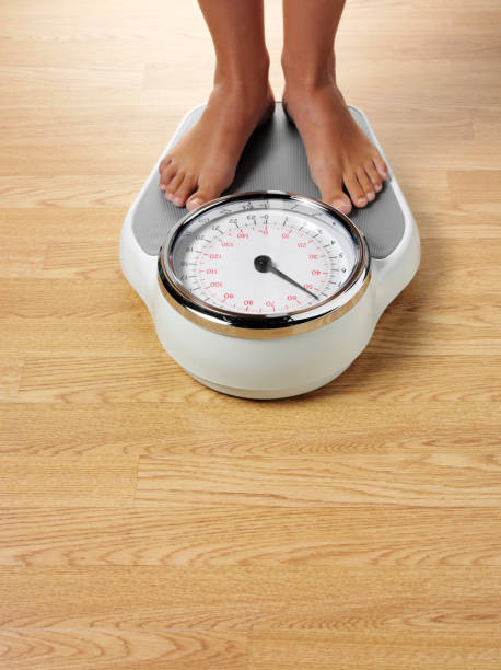 istock Female Standing on Bathroom Scales 182928996