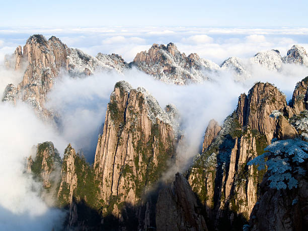 Mountains in the Clouds "Huangshan Mountain (Yellow Mountain), Anhui province, China." huangshan mountains stock pictures, royalty-free photos & images