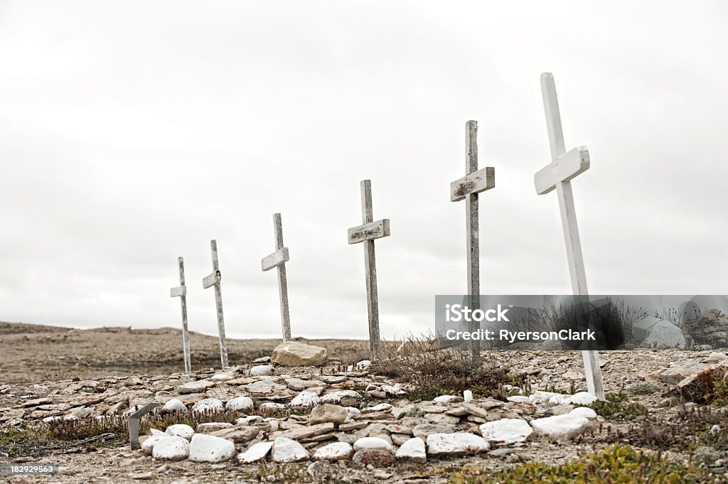 Arctic Grave Crosses, Nunavut canada. Crosses mark these lonely graves on the shores of the Northwest Passage in Canada's arctic territory of Nunavut.  Cloudy sky and barren ground. Canada Stock Photo