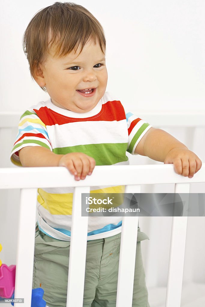 Cute baby boy Cute baby boy in his crib wearing striped shirtCheck out these similar images. :) Boys Stock Photo