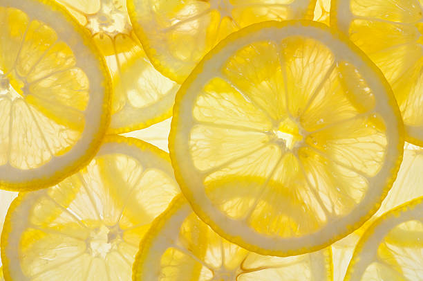 Lemons Backlit Lemon Slice Background citrus fruit stock pictures, royalty-free photos & images