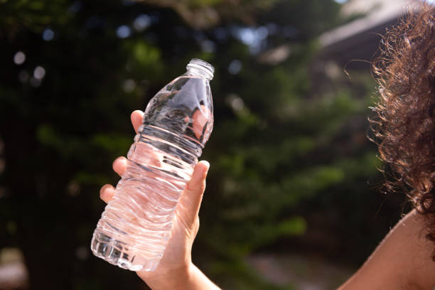 istock Unrecognizeable Woman Holding Plastic Water Bottle Oudoors on a Sunny Day 1829309970