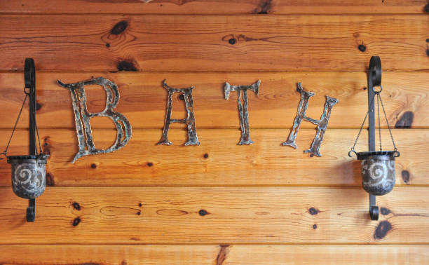 istock Rustic metalwork sign in the bathroom on wood paneling 1829311606