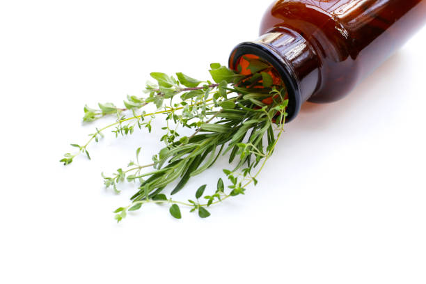 istock Medical bottle with herbs on white background. 1829328940