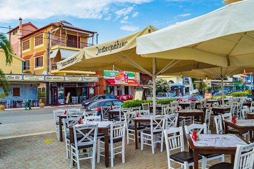 Lefkada,Greece-June 11th 2015;Outdoor restaurant seating at the quayside of  D-Marin Lefkas Marina on nice June day