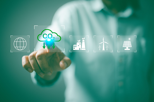 Carbon neutrality net zero. Hand of pollution and effective management with netzero symbols - renewable energy, reduced CO2 emissions, carbon credit to limit global warming from climate change.
