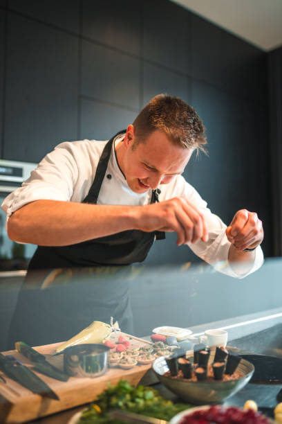 istock Talented Young Chef in Professional Uniform Creating Gourmet Delights 1829395210