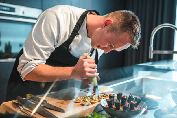 istock Precise and Skilled Chef Preparing Exquisite Dishes for Bachelorette Dinner 1829395262