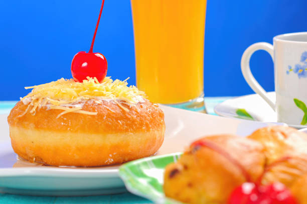 donuts decorated with cherries and sprinkled with cheese and powdered sugar