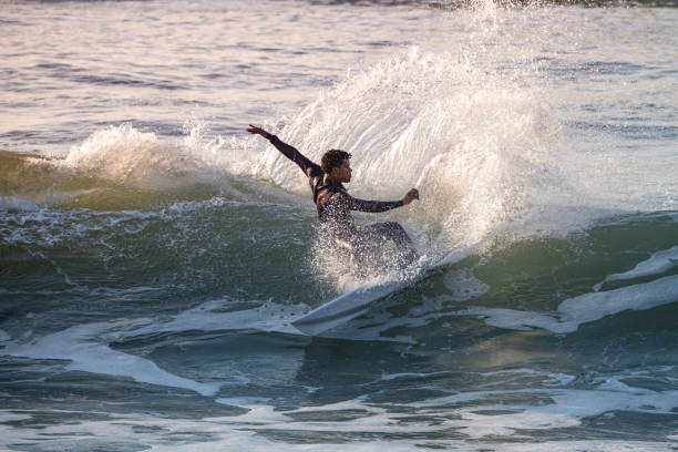 istock Brave teenager making tricks on the rough sea 1829454784