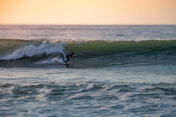 istock Brave teenager making tricks on the rough sea 1829455317