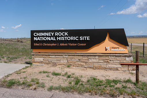 The entrance sign for Chimney Rock National Historic Site Ethel and Christopher J. Abbott Visitor Center in Morrill County in western Nebraska, USA - May 8, 2023.