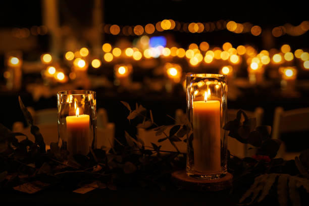 istock A romantic table setting with lit candles and greenery at a nighttime event. 1829479134