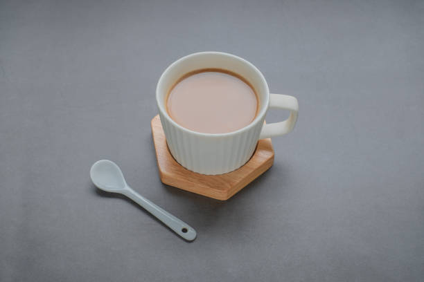 istock A cup of coffee with white spoon on black background 1829495348