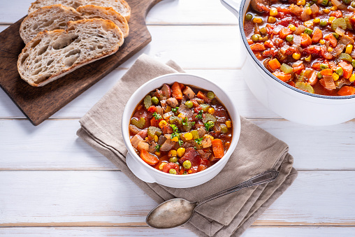 Bowl of Homemade Vegetable Soup with Peas, Corn, Carrot, Celery, Tomato, Onion and Thyme