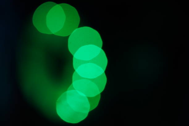 Greenish  bokeh balls on black background