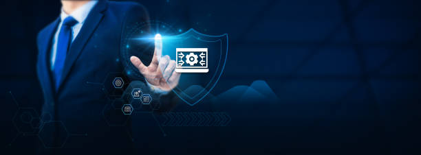 Businessman hand touches a digital asset management shield symbolizing protection. The concept of safeguarding digital assets and managing valuable resources securely to prevent data loss and unexpected disruptions. la mano de un hombre de negocios toca un escudo de gestión de activos digitales que simboliza la protección. el concepto de salvaguardar los activos digitales y gestionar los recursos valiosos de forma segura para evitar la pérdida de datos y las interr