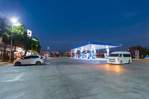 Modern Service Station with convenience store and a few cars, in a Sunny Day