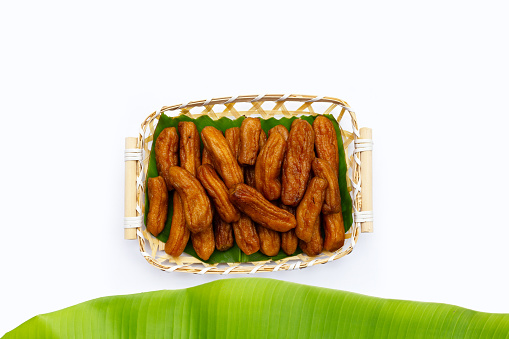 Sun-dried bananas on white background.
