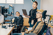 People with varying abilities working together in a small office