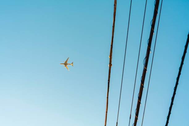 istock Power lines and passenger aircraft. 1829670075