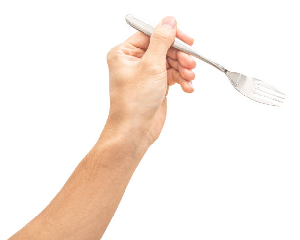 istock isolated of a man's hand holding a silver steel fork. 1829672825