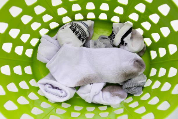 istock Dirty white socks in laundry basket 1829700960