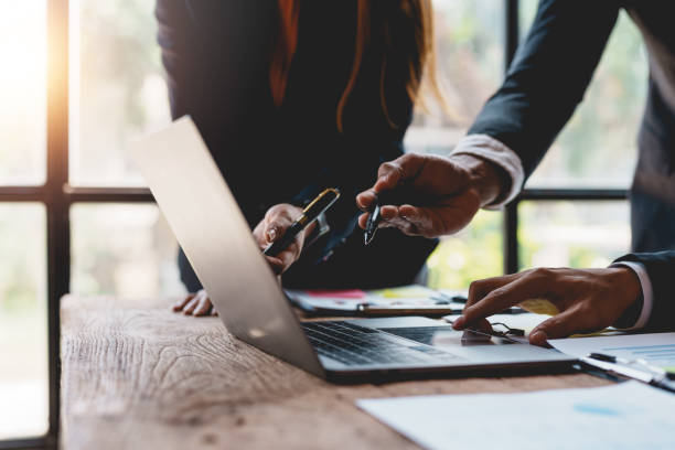 istock Businesspeople hand pointing at laptop computer to view business figures, graphs, charts, analyzing corporate finance marketing concepts Plan a marketing strategy on a laptop. 1829709302