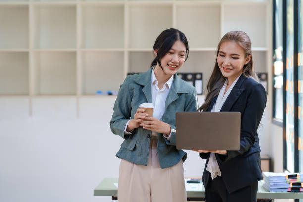 istock Two Asian businesswomen discussing a startup project concept presentation Analysis of planning and financial statistics and investment markets at office. 1829711437