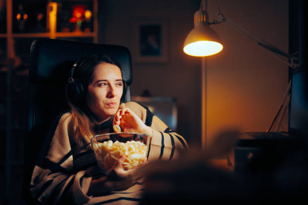 Funny Woman Eating Chips Watching a Show on her Laptop