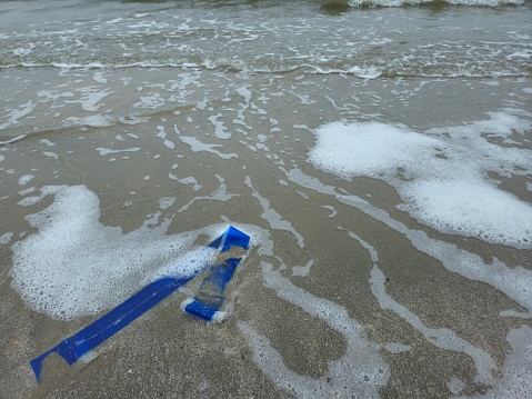 Strip Of Plastic Pollution Laying On Beach