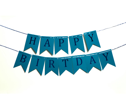 happy birthday inscription with colorful letters as a birthday decoration attached on white background