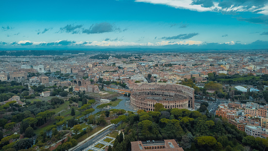 Aerial drone view of Colosseum in rome on an autumn morning, wiewed from the south gardens. Epic sky above the colosseum, famous monument in the central italy.