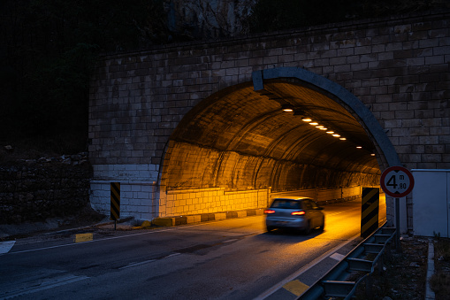 Illuminated tunnel through a mountain.