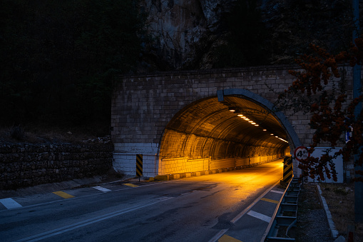 Illuminated tunnel through a mountain.