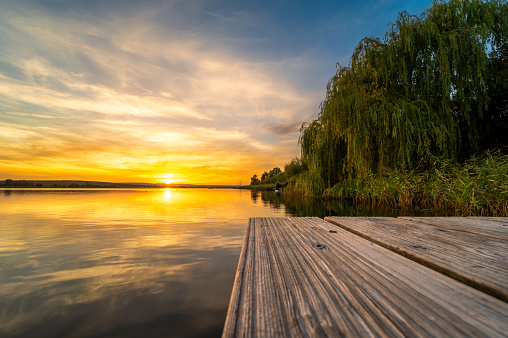 Enjoying the sunset at a lake on a wooden pier