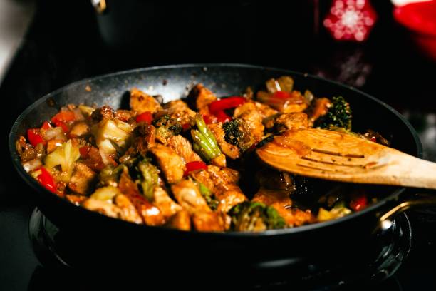 istock Close-up of vegetables and chicken fried in a pan 1829853416
