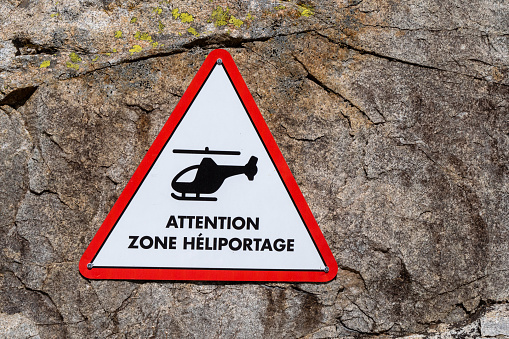 a sign indicating the helicopter landing area for mountain , France