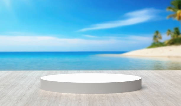 istock White round platform on wooden deck with blurred beach background. 1829880595