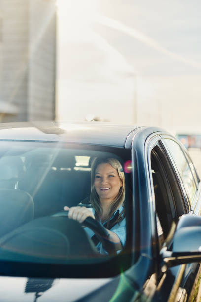 istock Happy female entrepreneur going on a trip by car. 1829899232