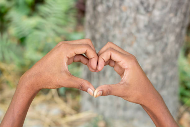 istock A man made a love sign with his hand and blurred background 1829914758