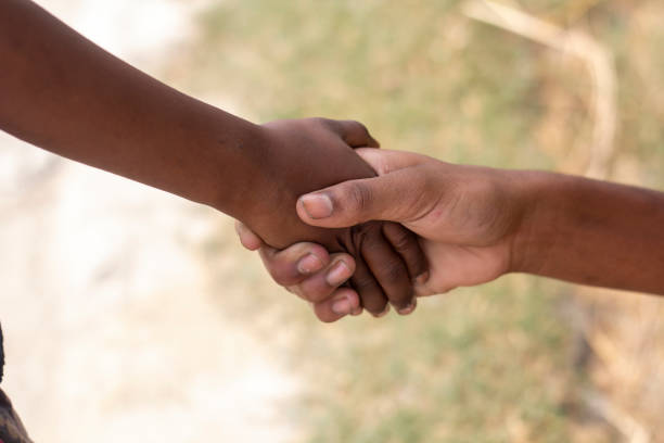 istock A man making handshake with another man and blurred background 1829915872