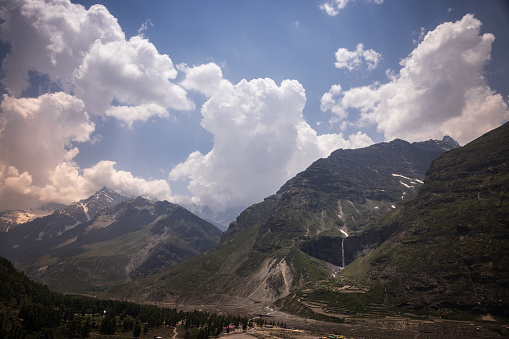 Massive Himalayan mountains with moody sky and speckled light, en route Manali to Leh, Himachal Pradesh