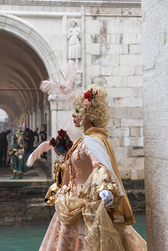 Venice, Italy - February 10, 2018: Three people in Venetian costume attends the Carnival of Venice