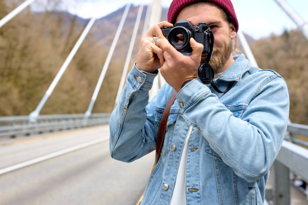 istock Active Handsome Photographer man Taking Photo on camer while walking, traveling 1829947901