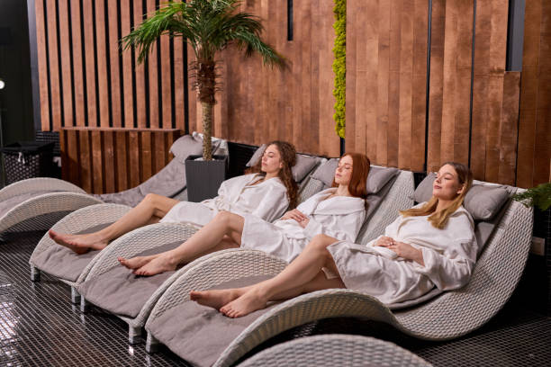 istock Side View On Relaxed Women Having Rest After Spa, In Bathrobe 1829949557