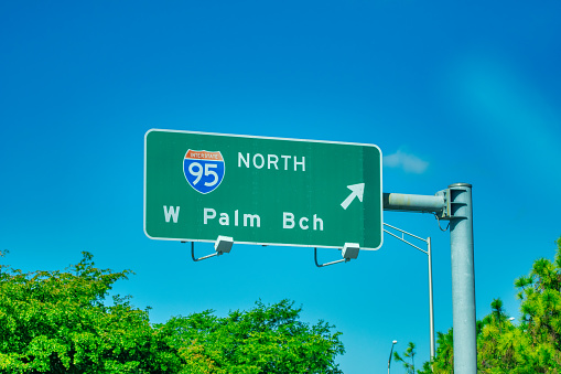 Road traffic sign for exits 260 A, B and C in Daytona Beach, Florida with direction to Orlando city on 92 or 400 local roads with interstate highway 4 in summer