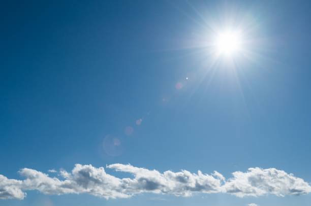 istock Sun radiating in the beautiful blue sky, creating a perfect backdrop to any project 1829958995