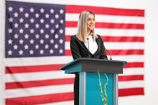 American female politician giving a speech at a podium