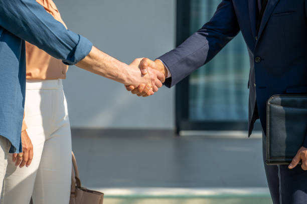 istock Real estate agent and buyer handshake 1829978404